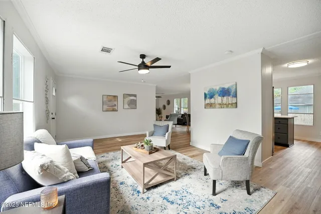 a living room with furniture and wooden floor