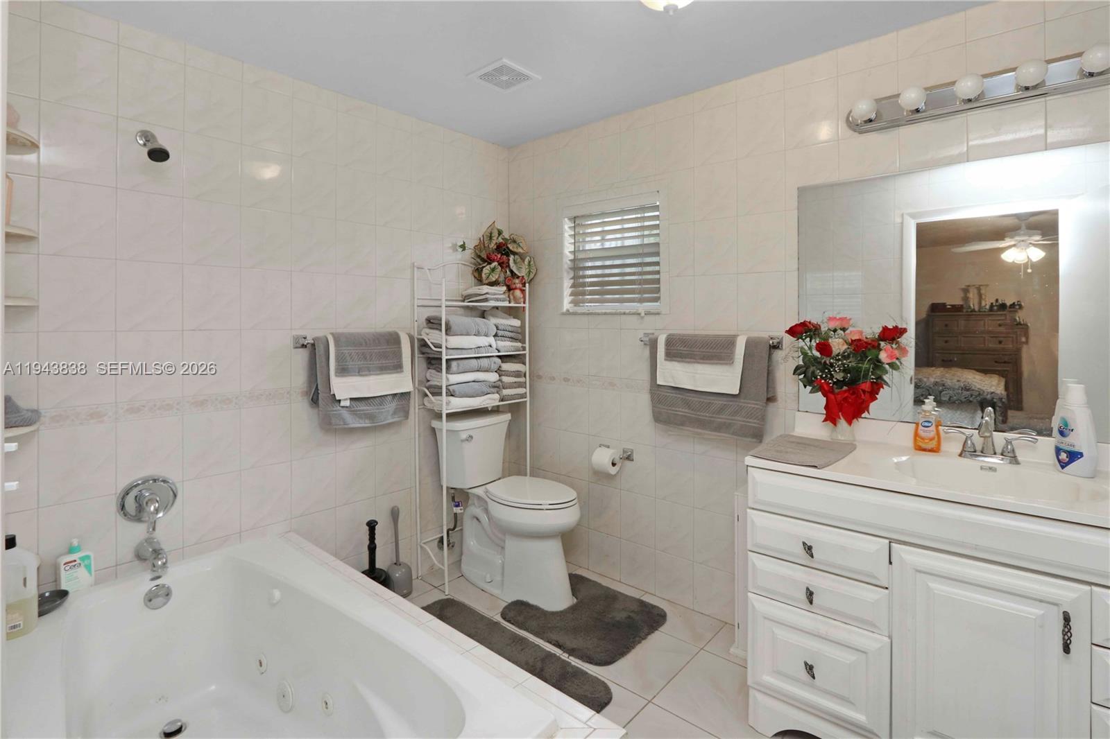 13243 Southwest 258th Terrace Homestead, FL 33032 - Photo 16 of 25 a bathroom with a sink a toilet and mirror