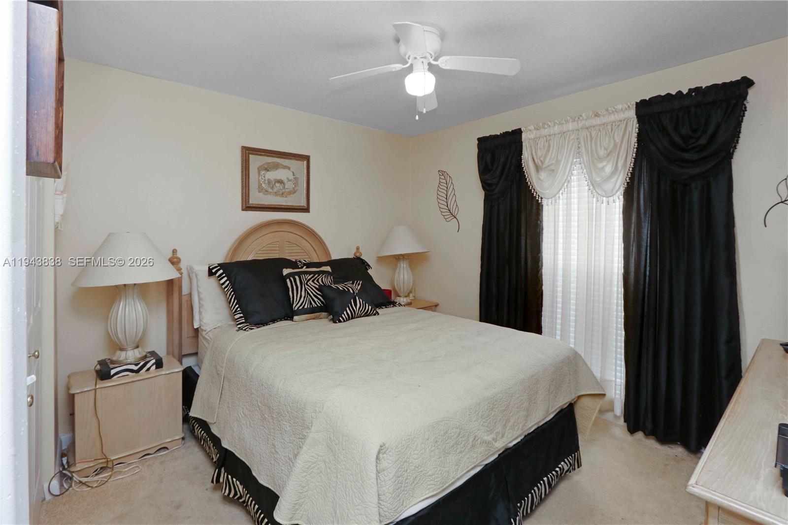 13243 Southwest 258th Terrace Homestead, FL 33032 - Photo 18 of 25 a bedroom with bed and a chandelier