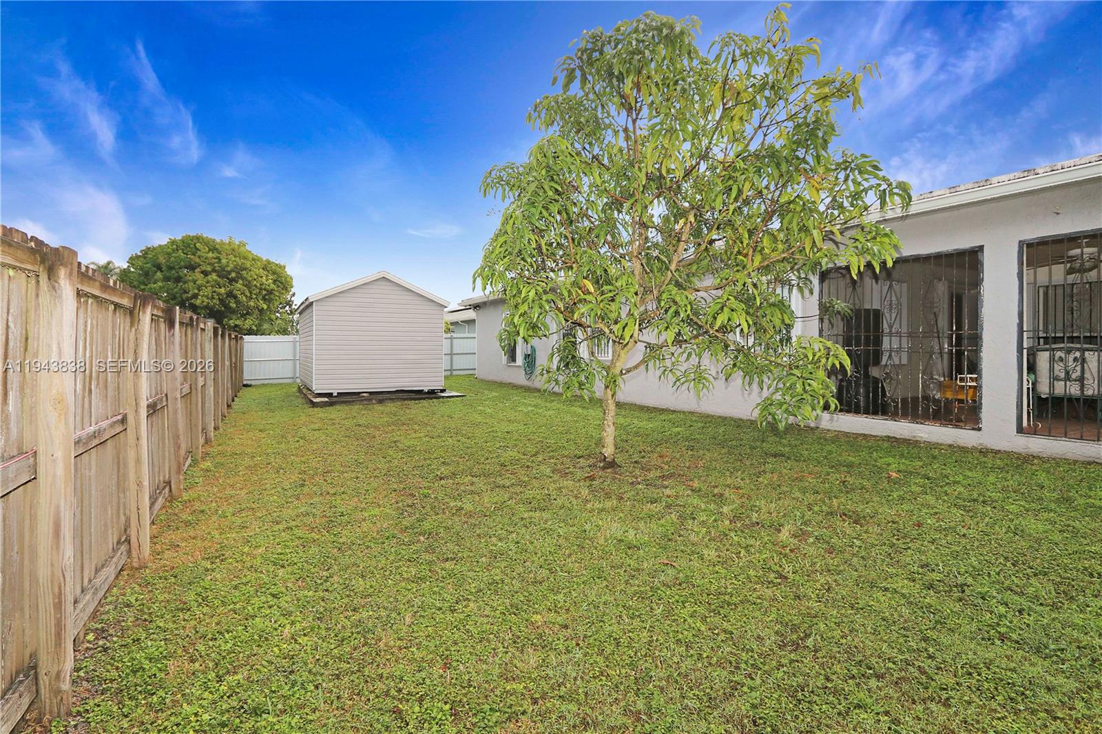 13243 Southwest 258th Terrace Homestead, FL 33032 - Photo 23 of 25 a house with trees in front of it