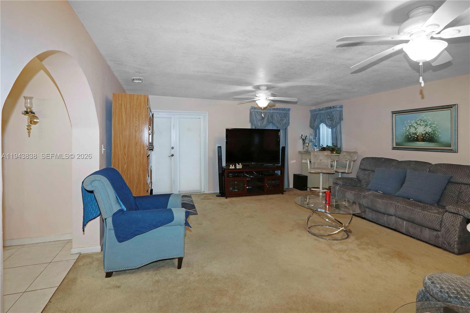 13243 Southwest 258th Terrace Homestead, FL 33032 - Photo 6 of 25 a living room with furniture and a flat screen tv