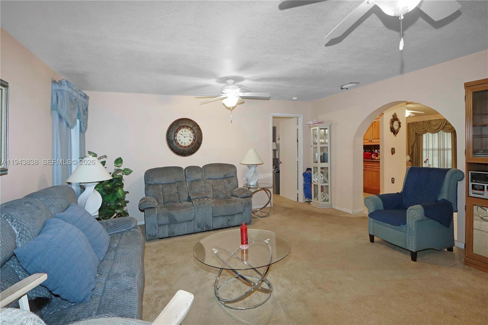13243 Southwest 258th Terrace Homestead, FL 33032 - Photo 7 of 25 a living room with furniture and a chandelier