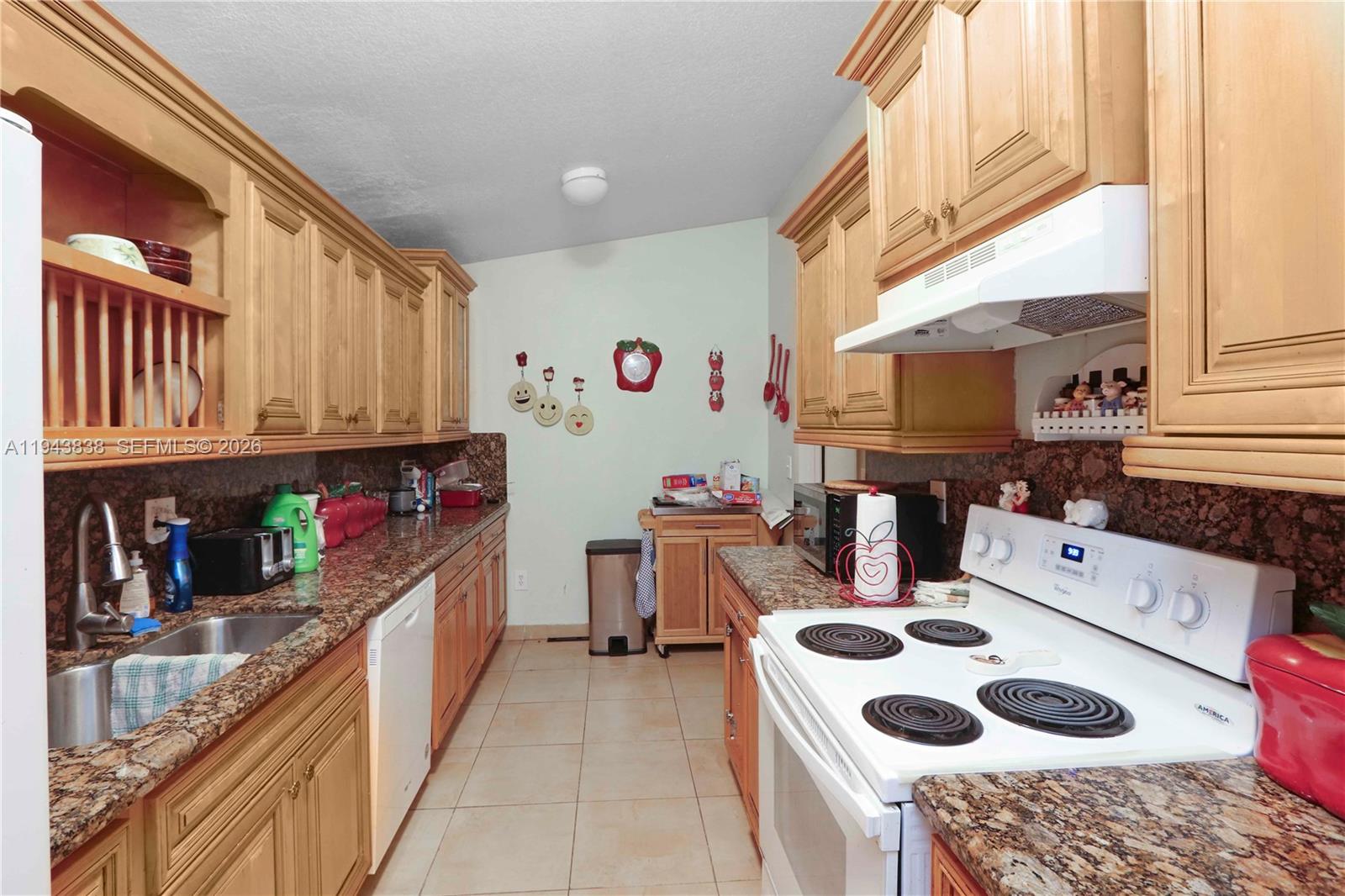 13243 Southwest 258th Terrace Homestead, FL 33032 - Photo 9 of 25 a kitchen with a sink a stove and a refrigerator