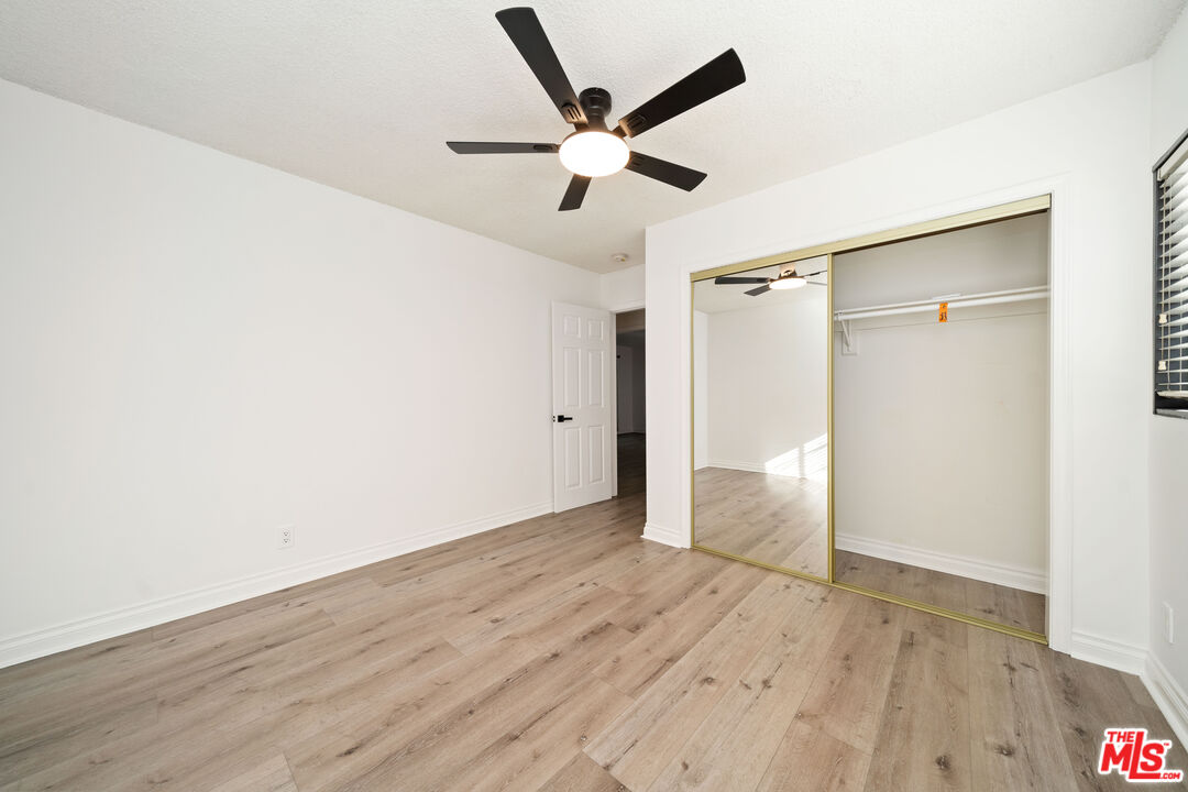 8933 Cadillac Avenue, Unit 4 Los Angeles, CA 90034 - Photo 13 of 17 a view of an empty room with wooden floor