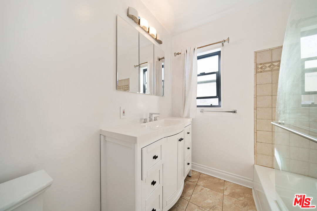 8933 Cadillac Avenue, Unit 4 Los Angeles, CA 90034 - Photo 14 of 17 a bathroom with a sink a toilet and shower