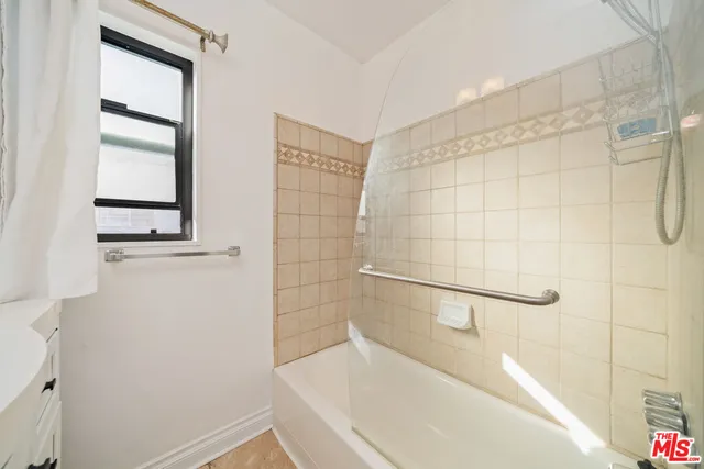 a bathroom with a bathtub and shower