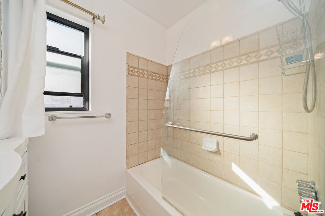 8933 Cadillac Avenue, Unit 4 Los Angeles, CA 90034 - Photo 15 of 17 a bathroom with a bathtub and shower