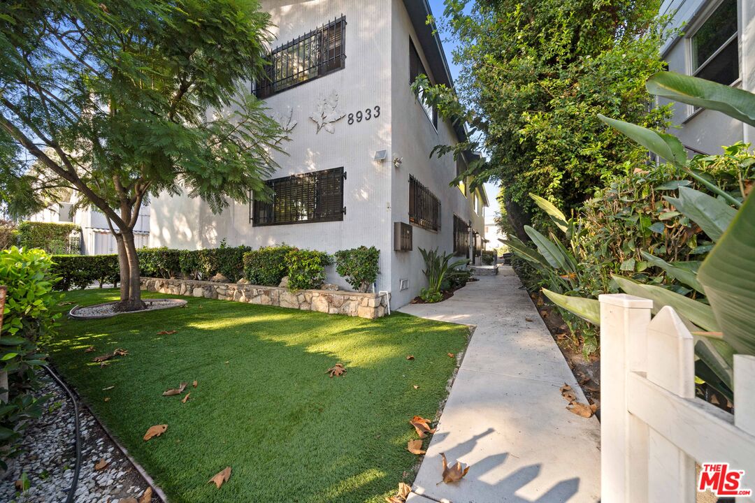 8933 Cadillac Avenue, Unit 4 Los Angeles, CA 90034 - Photo 2 of 17 a view of a backyard with couches plants and large trees