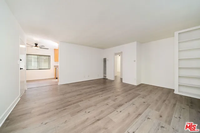 a view of an empty room and wooden floor