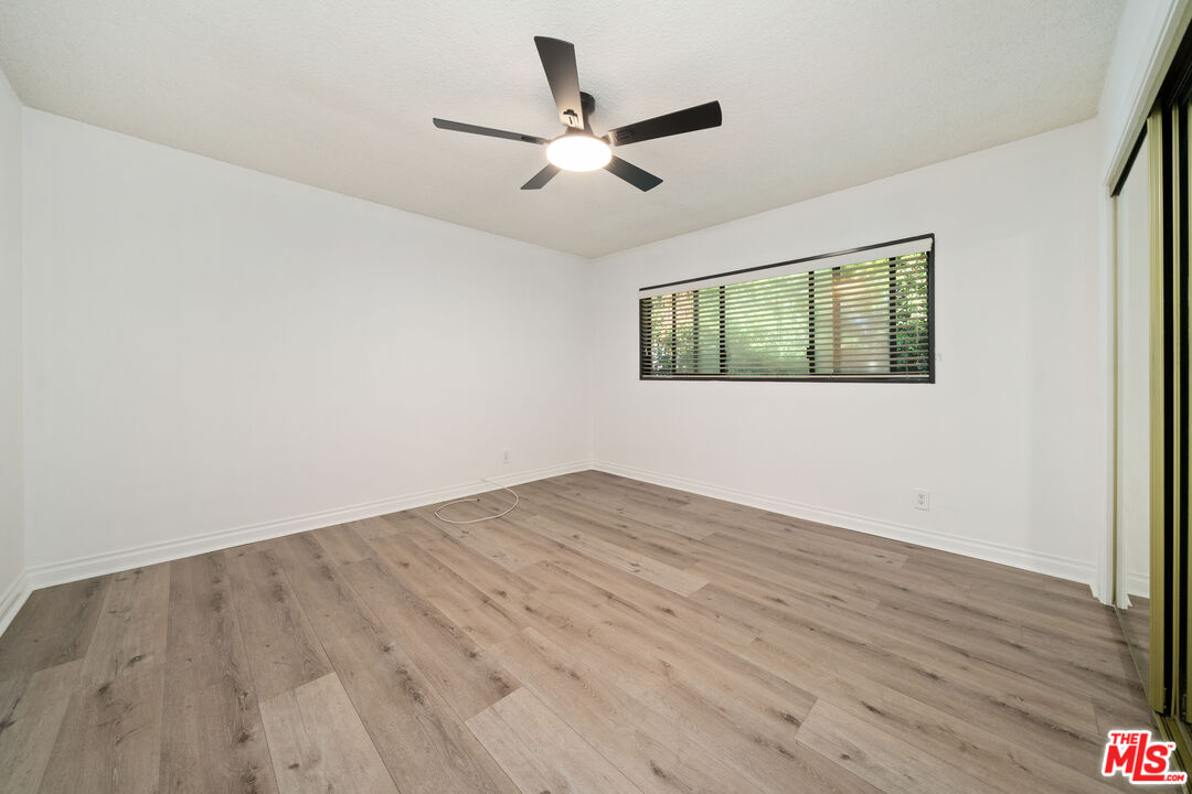 8933 Cadillac Avenue, Unit 4 Los Angeles, CA 90034 - Photo 10 of 17 wooden floor in an empty room with a window