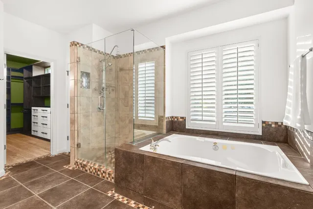 a bathroom with a bathtub and a shower