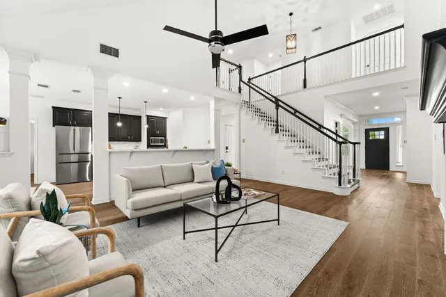 a living room with furniture and kitchen view