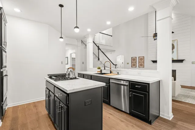 a kitchen with a stove sink and a refrigerator