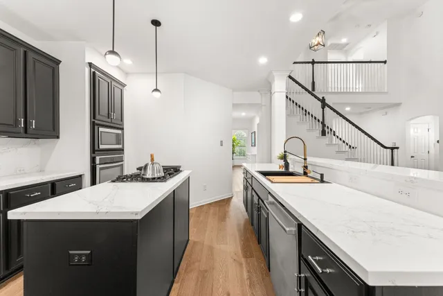 a kitchen with a sink a stove and a refrigerator