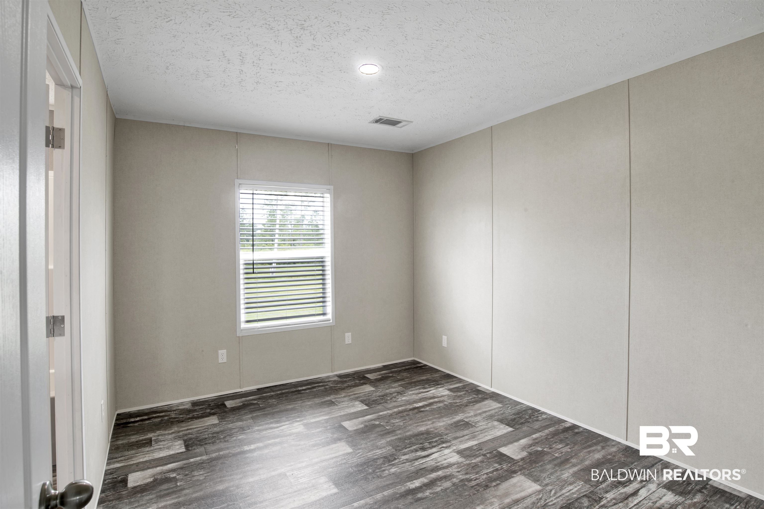 16778 County Road 87 Elberta, AL 36530 - Photo 24 of 32 Empty room featuring a textured ceiling and hardwood / wood-style floors