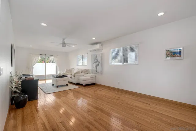 a living room with furniture window and wooden floor