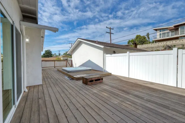 a roof deck view with a wooden floor