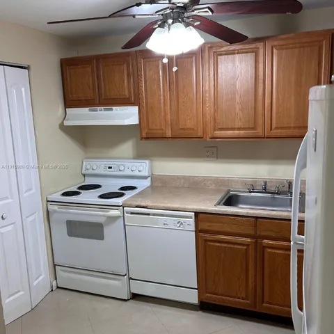 a kitchen with cabinets and appliances