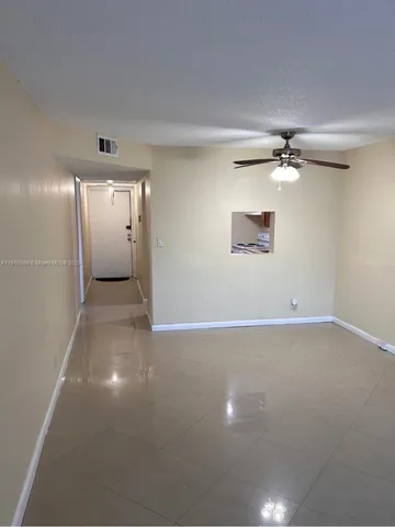 a view of a room with a ceiling fan
