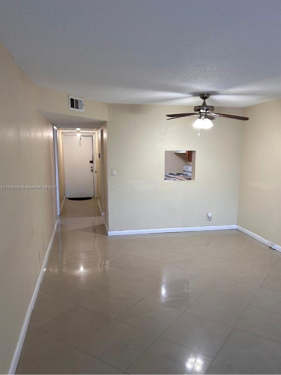 7920 North Colony Circle, Unit 107 Tamarac, FL 33321 - Photo 6 of 11 a view of a room with a ceiling fan