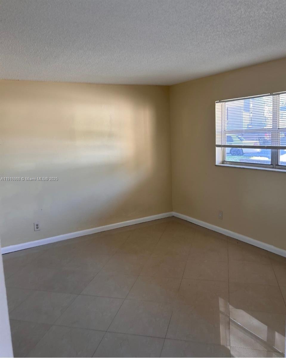 7920 North Colony Circle, Unit 107 Tamarac, FL 33321 - Photo 8 of 11 a view of an empty room with a window