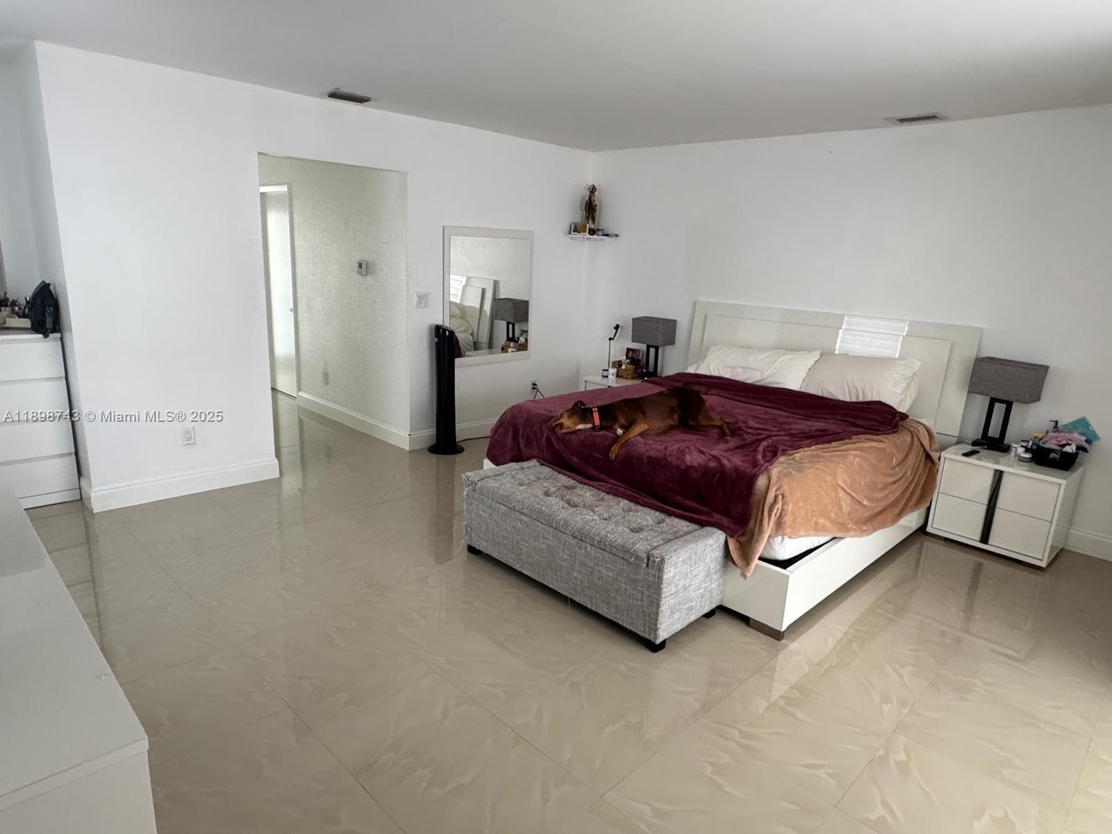 12100 Southwest 271st Street, Unit 12100 Homestead, FL 33032 - Photo 11 of 24 a spacious bedroom with a bed and a cabinets