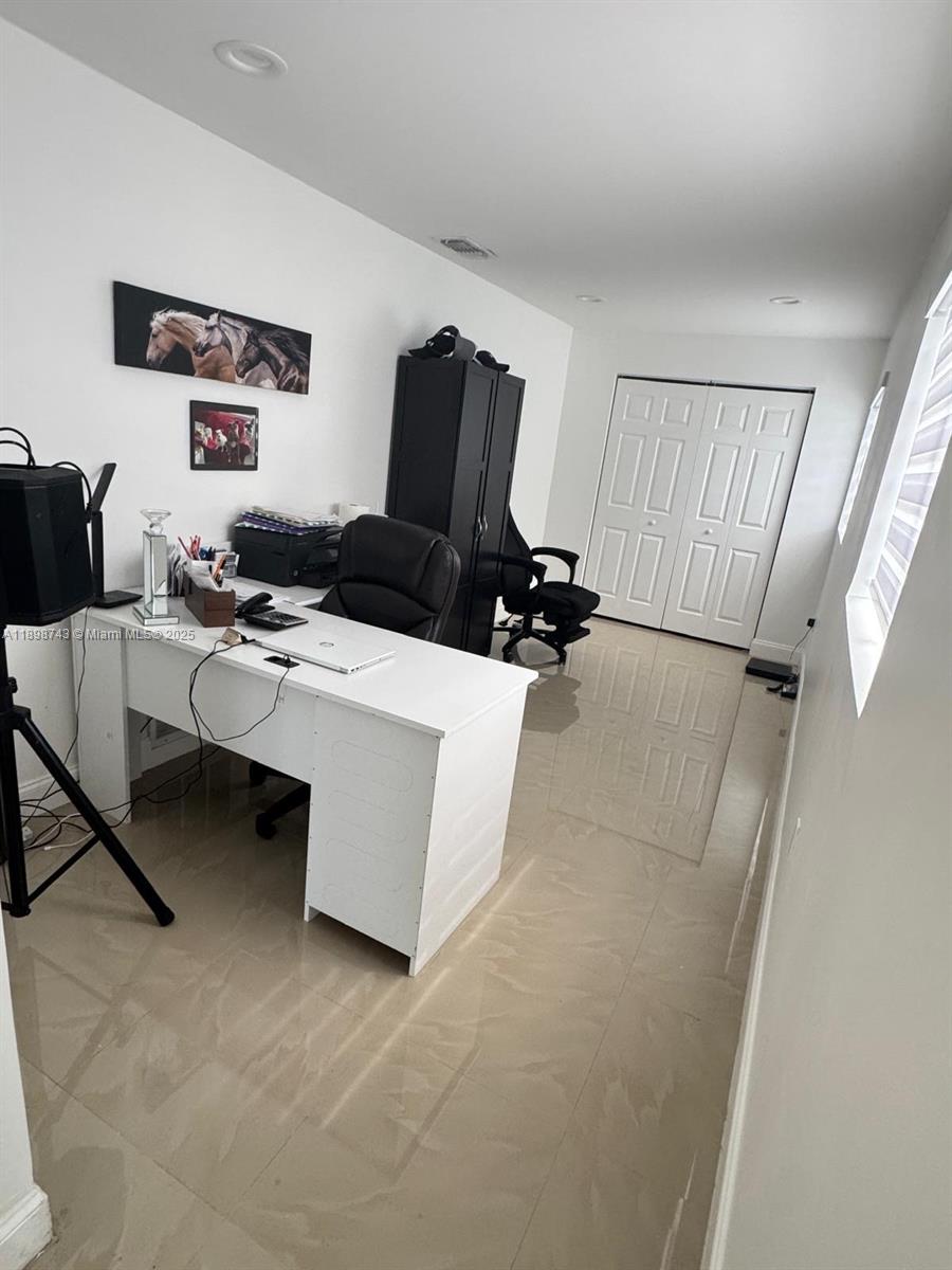 12100 Southwest 271st Street, Unit 12100 Homestead, FL 33032 - Photo 12 of 24 a living room with furniture and a flat screen tv
