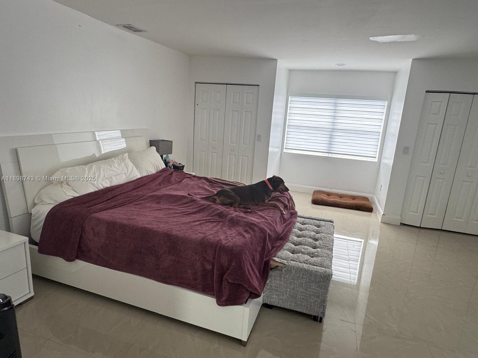 12100 Southwest 271st Street, Unit 12100 Homestead, FL 33032 - Photo 13 of 24 a bedroom with a bed and a window