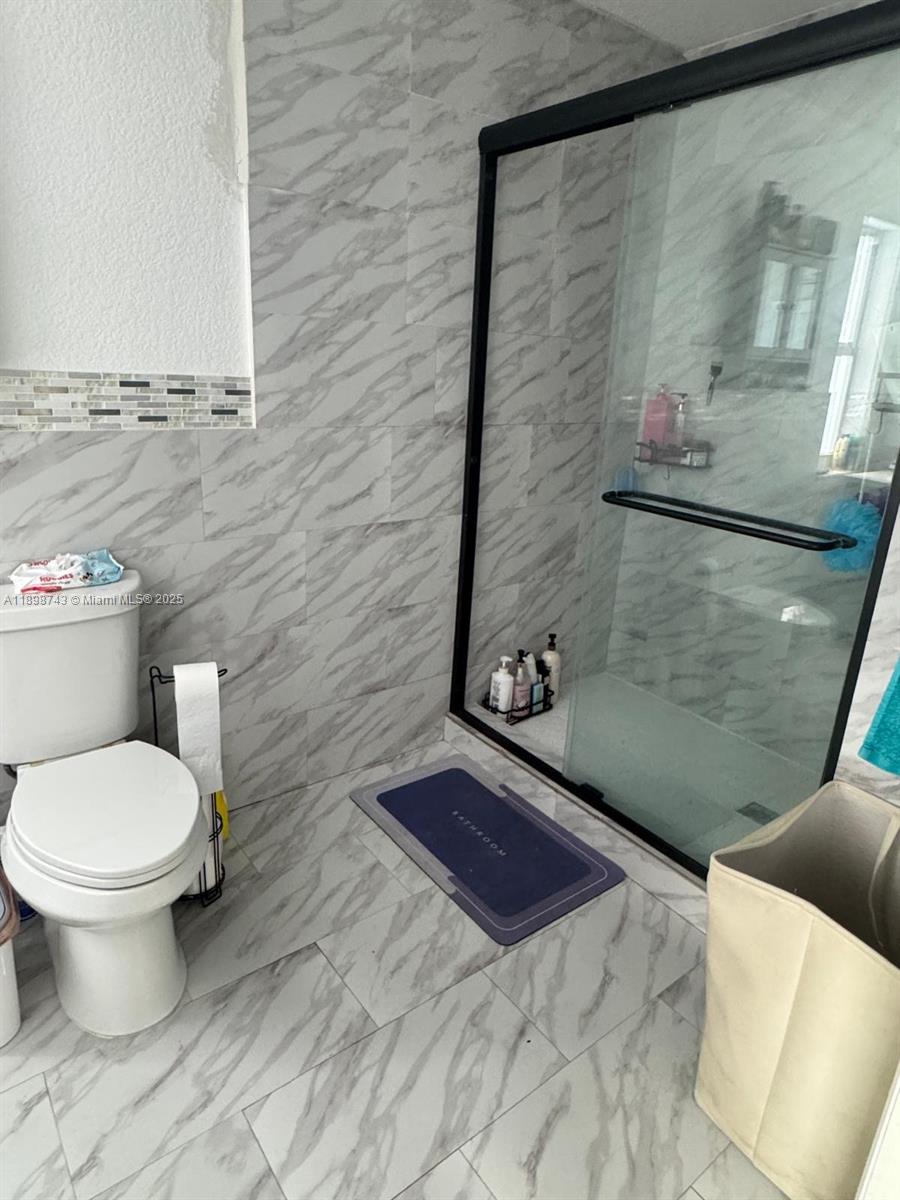 12100 Southwest 271st Street, Unit 12100 Homestead, FL 33032 - Photo 15 of 24 a bathroom with a toilet and a shower