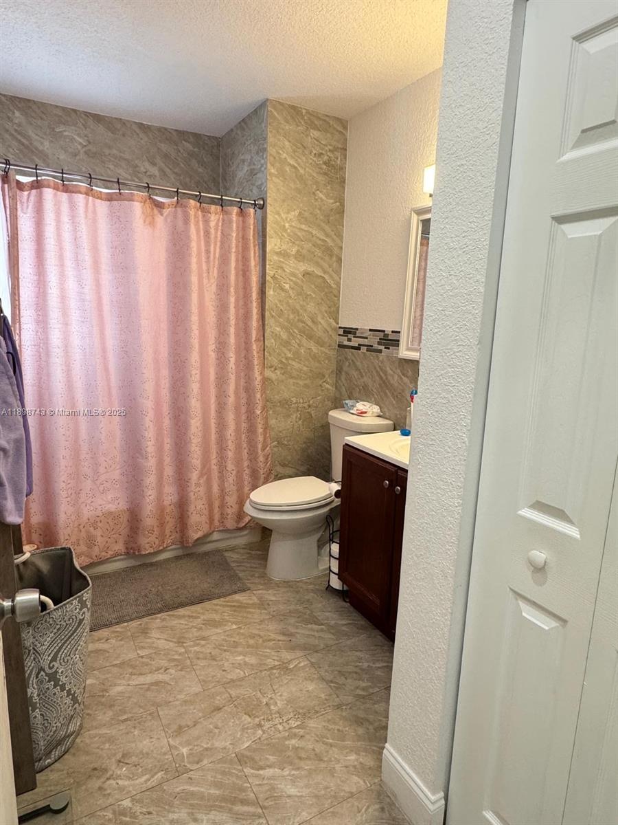12100 Southwest 271st Street, Unit 12100 Homestead, FL 33032 - Photo 18 of 24 a bathroom with a sink toilet and shower