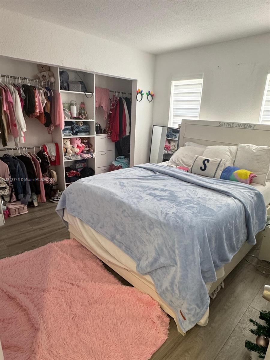 12100 Southwest 271st Street, Unit 12100 Homestead, FL 33032 - Photo 19 of 24 a bedroom with bed and walk in closet