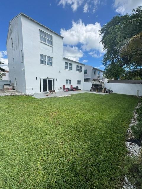 12100 Southwest 271st Street, Unit 12100 Homestead, FL 33032 - Photo 22 of 24 a view of a house with a big yard and large trees