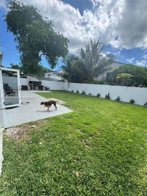 12100 Southwest 271st Street, Unit 12100 Homestead, FL 33032 - Photo 24 of 24 a view of a swimming pool with an outdoor seating and a garden