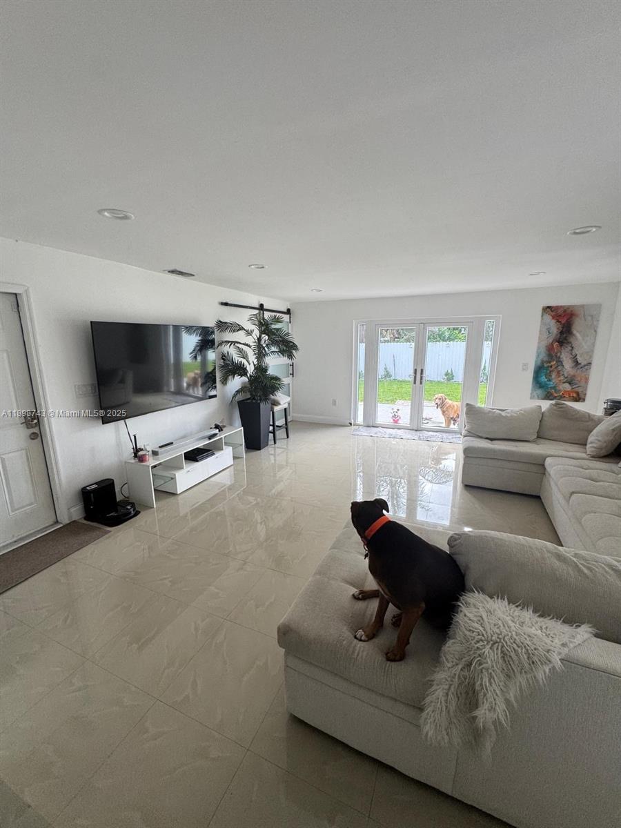 12100 Southwest 271st Street, Unit 12100 Homestead, FL 33032 - Photo 5 of 24 a living room with furniture and a flat screen tv