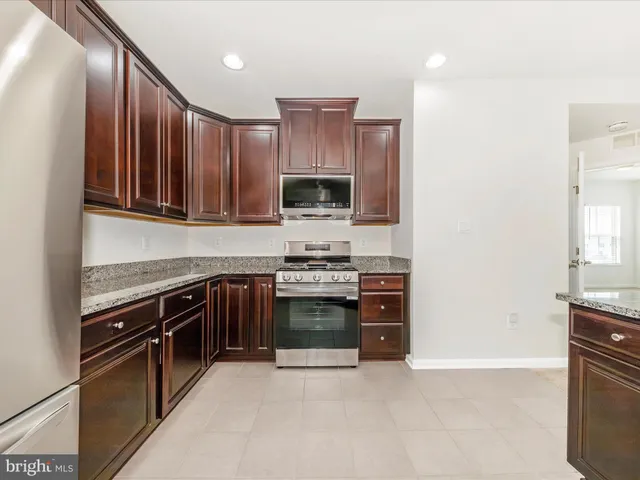 an empty room with windows and fireplace