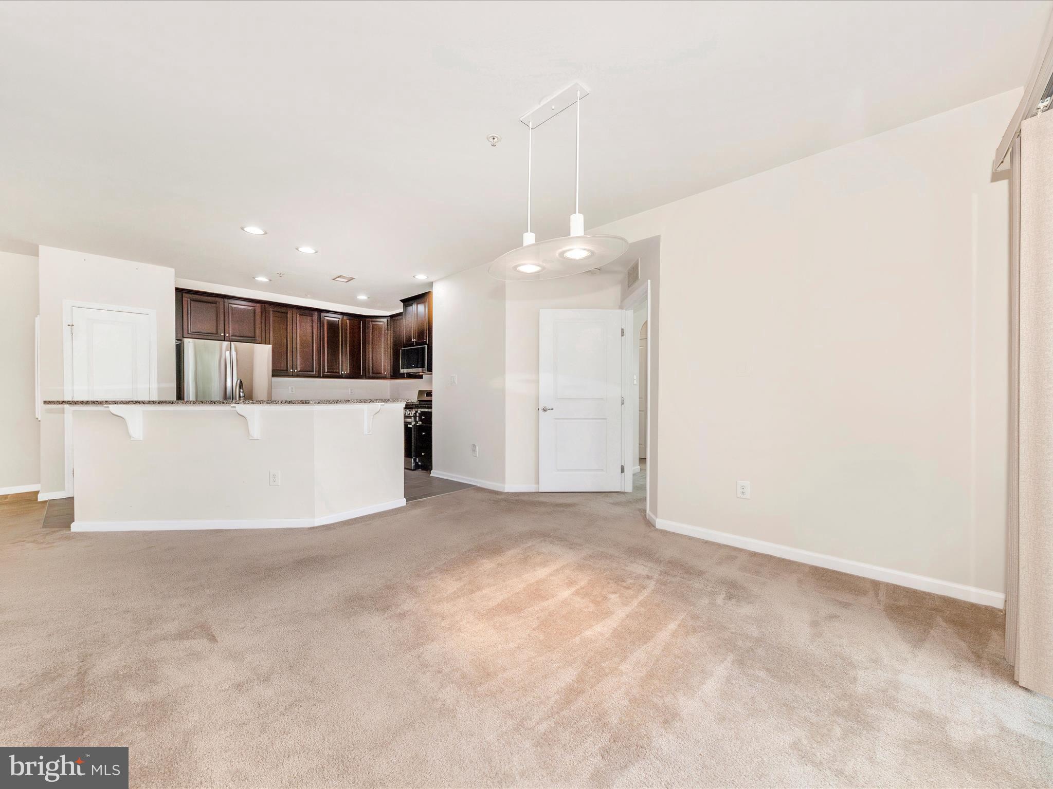 6501 Walcott Lane, Unit 202 Frederick, MD 21703 - Photo 20 of 53 a view of a kitchen with a sink and white cabinets