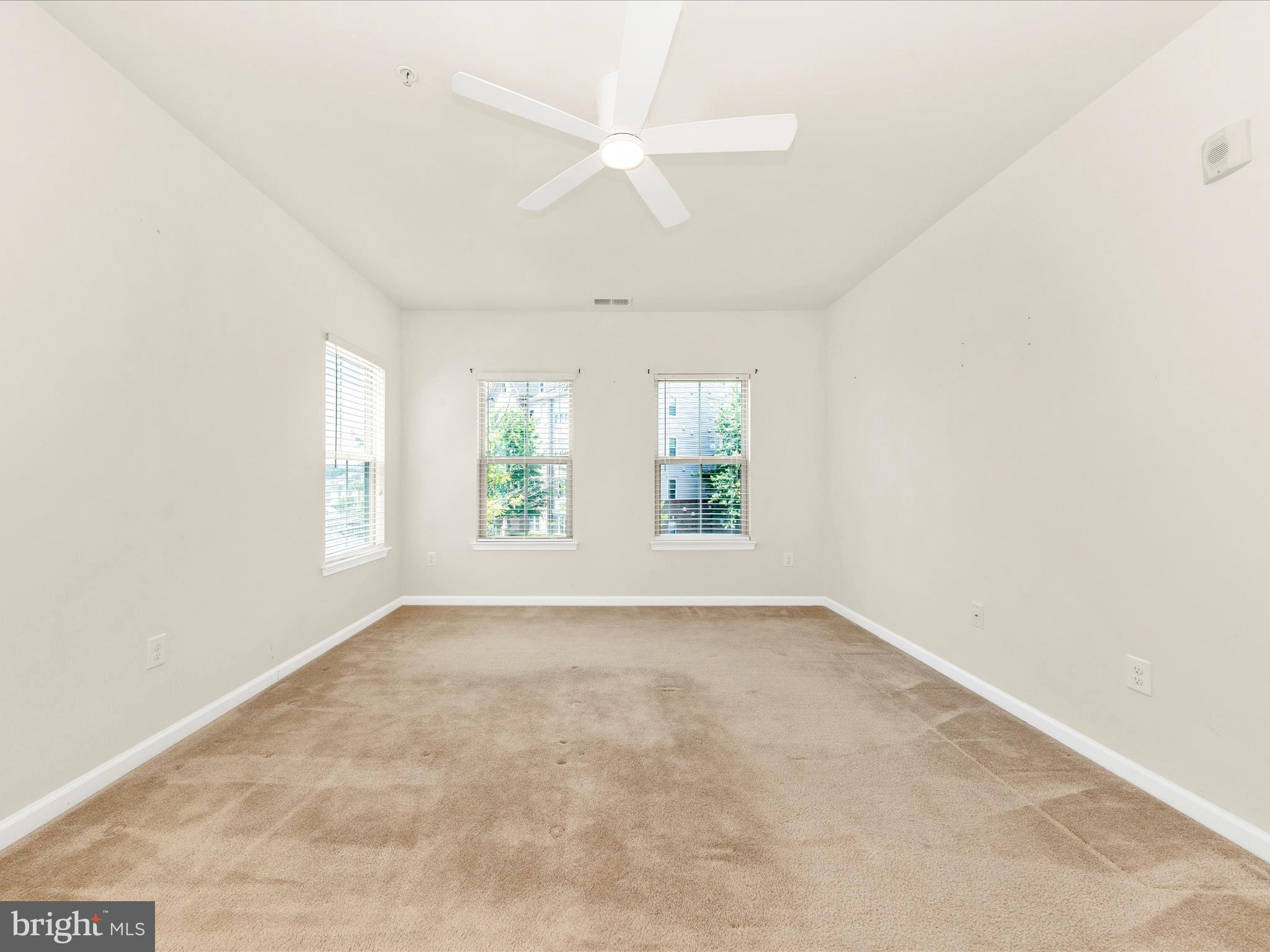 6501 Walcott Lane, Unit 202 Frederick, MD 21703 - Photo 24 of 53 an empty room with windows and chandelier fan