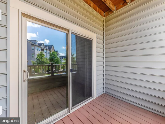 a front view of a house with a yard and potted plants