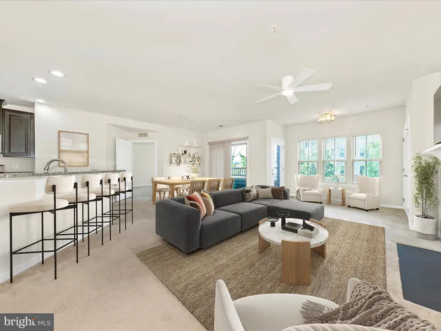 a view of a livingroom with a ceiling fan and window