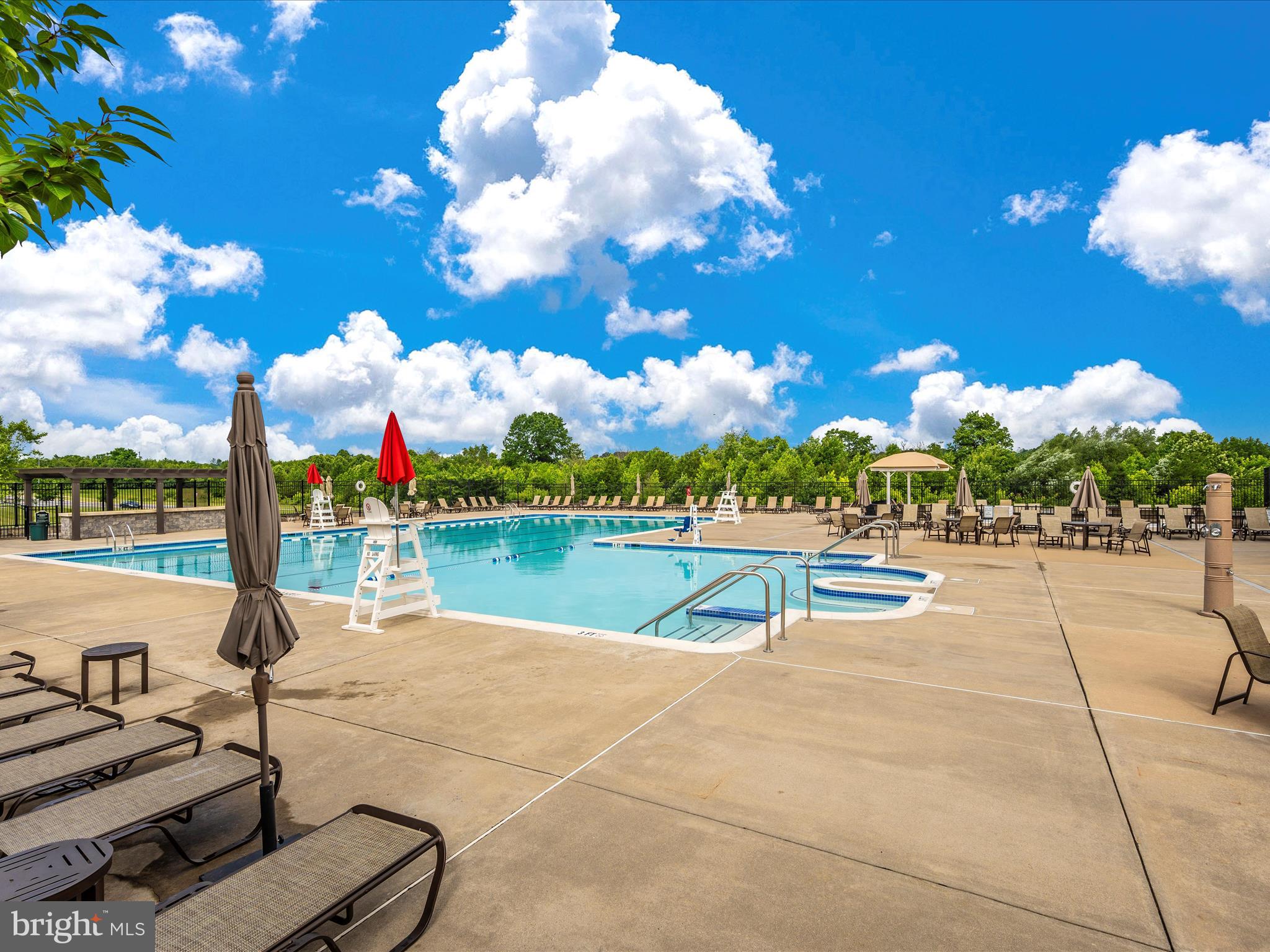 6501 Walcott Lane, Unit 202 Frederick, MD 21703 - Photo 42 of 53 a view of a swimming pool and lounge chairs