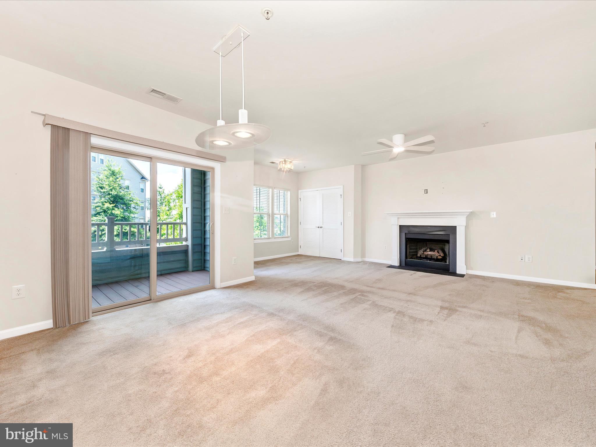 6501 Walcott Lane, Unit 202 Frederick, MD 21703 - Photo 5 of 53 a view of a livingroom with a ceiling fan and window