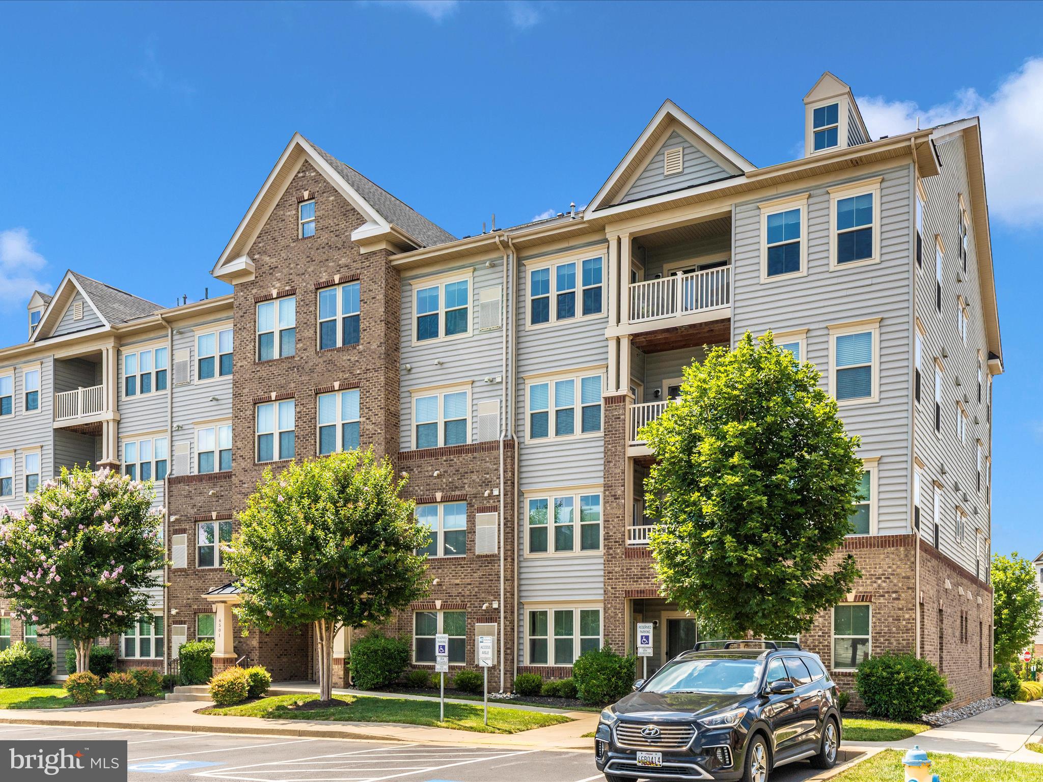 6501 Walcott Lane, Unit 202 Frederick, MD 21703 - Photo 52 of 53 a front view of a residential apartment building with a yard