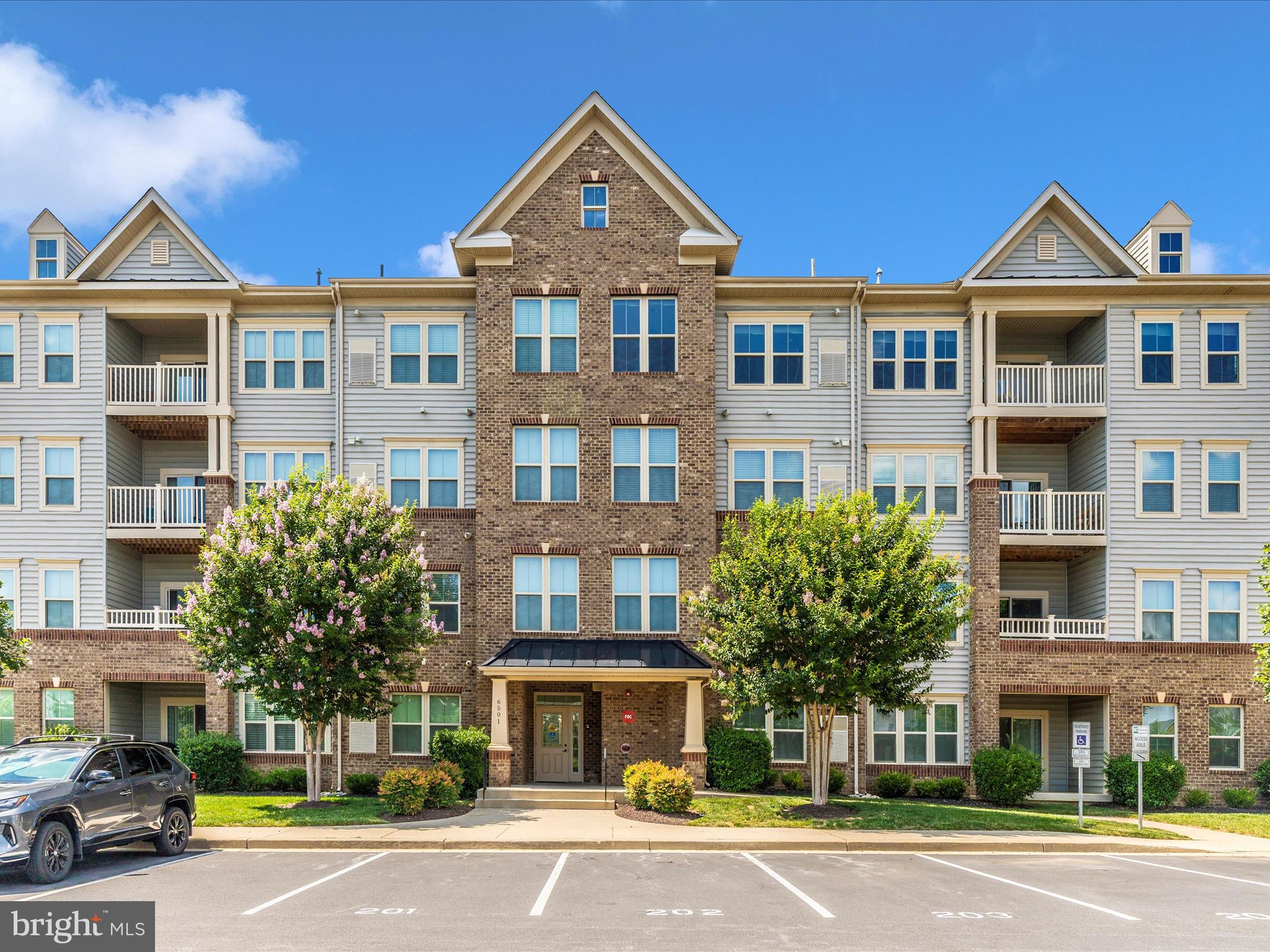 6501 Walcott Lane, Unit 202 Frederick, MD 21703 - Photo 53 of 53 a front view of a residential apartment building with a yard