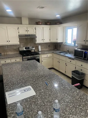 a kitchen with a sink and cabinets