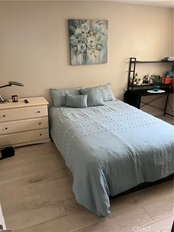 a bedroom with a bed and lamp