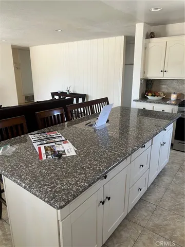 a kitchen with stainless steel appliances granite countertop a sink and a white counter tops