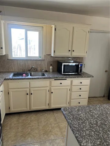 a kitchen with appliances cabinets and a window