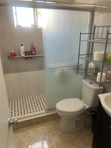 a bathroom with a toilet and a shower curtain