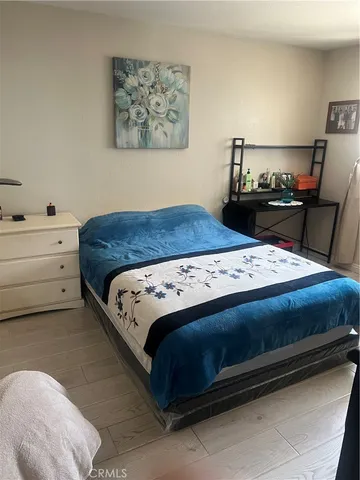 a bedroom with a bed and dresser