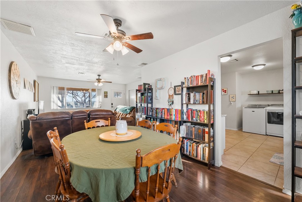 13336 Clement Edwards, CA 93523 - Photo 11 of 56 a view of a dining room and livingroom with furniture wooden floor a rug a painting and a chandelier